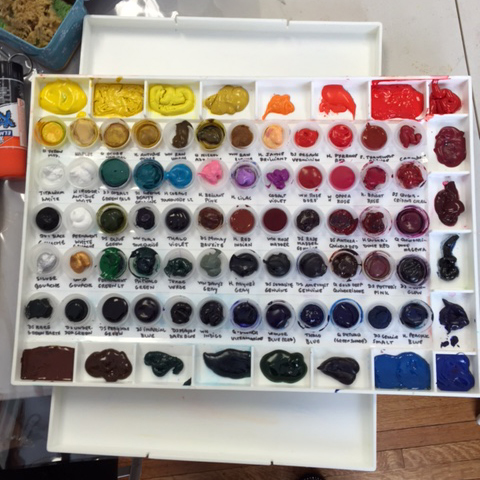 And here is the cool paint storage idea she shared with us. Those are water bottle caps!