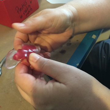 Here you can see Loni kneading the color into the softened plastic before shaping.
