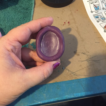 Katie used an old mold she made years ago when she use to make jewelry out of epoxy resin clay. You can see the softened plastic in the mold here.